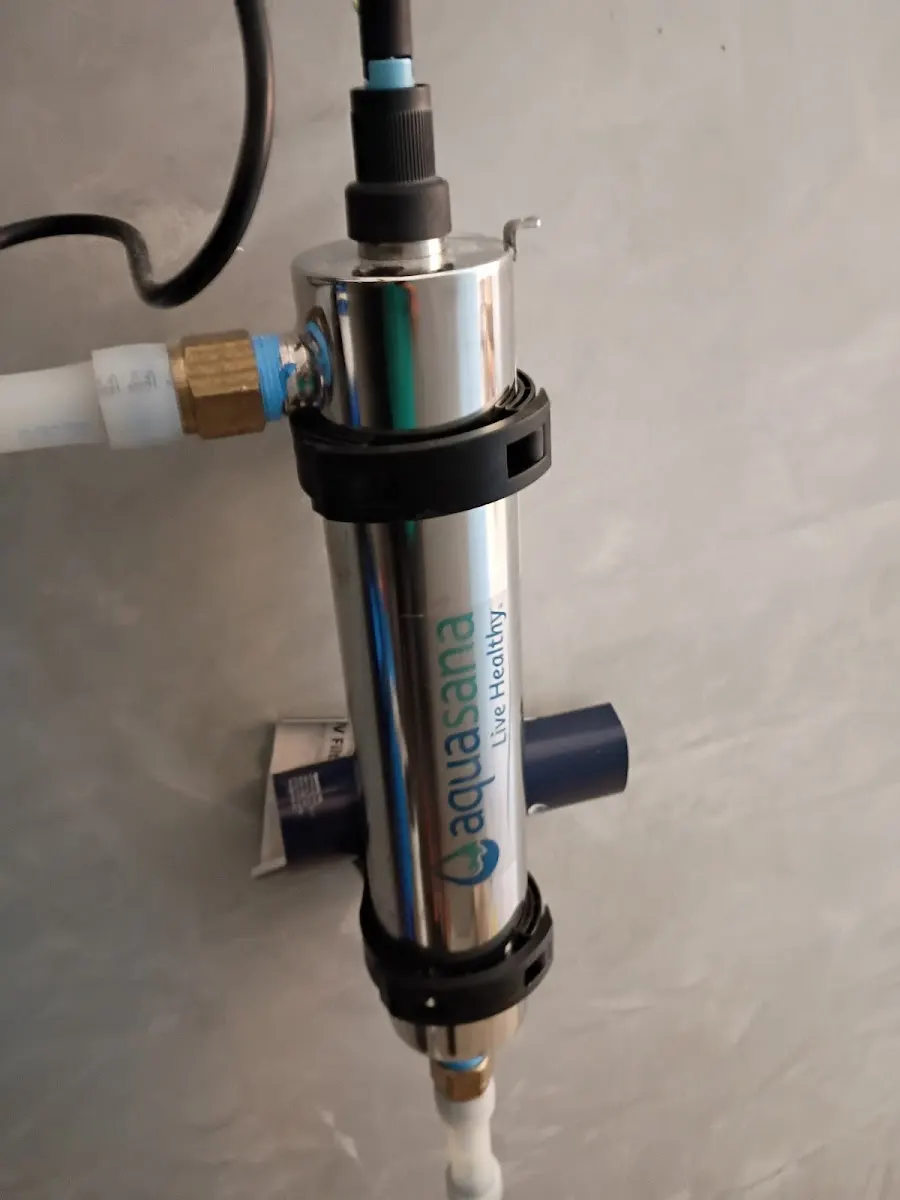 Water Softner installation Close-up of a stainless steel Aquasana UV water filtration system component professionally installed on a wall by a Largo, FL plumbing company.