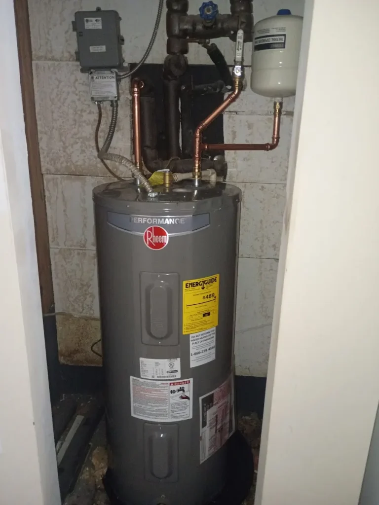 Water Heater Replacement Largo Professionally installed Rheem Performance electric water heater with new copper water lines and a thermal expansion tank in a Largo, FL utility closet.