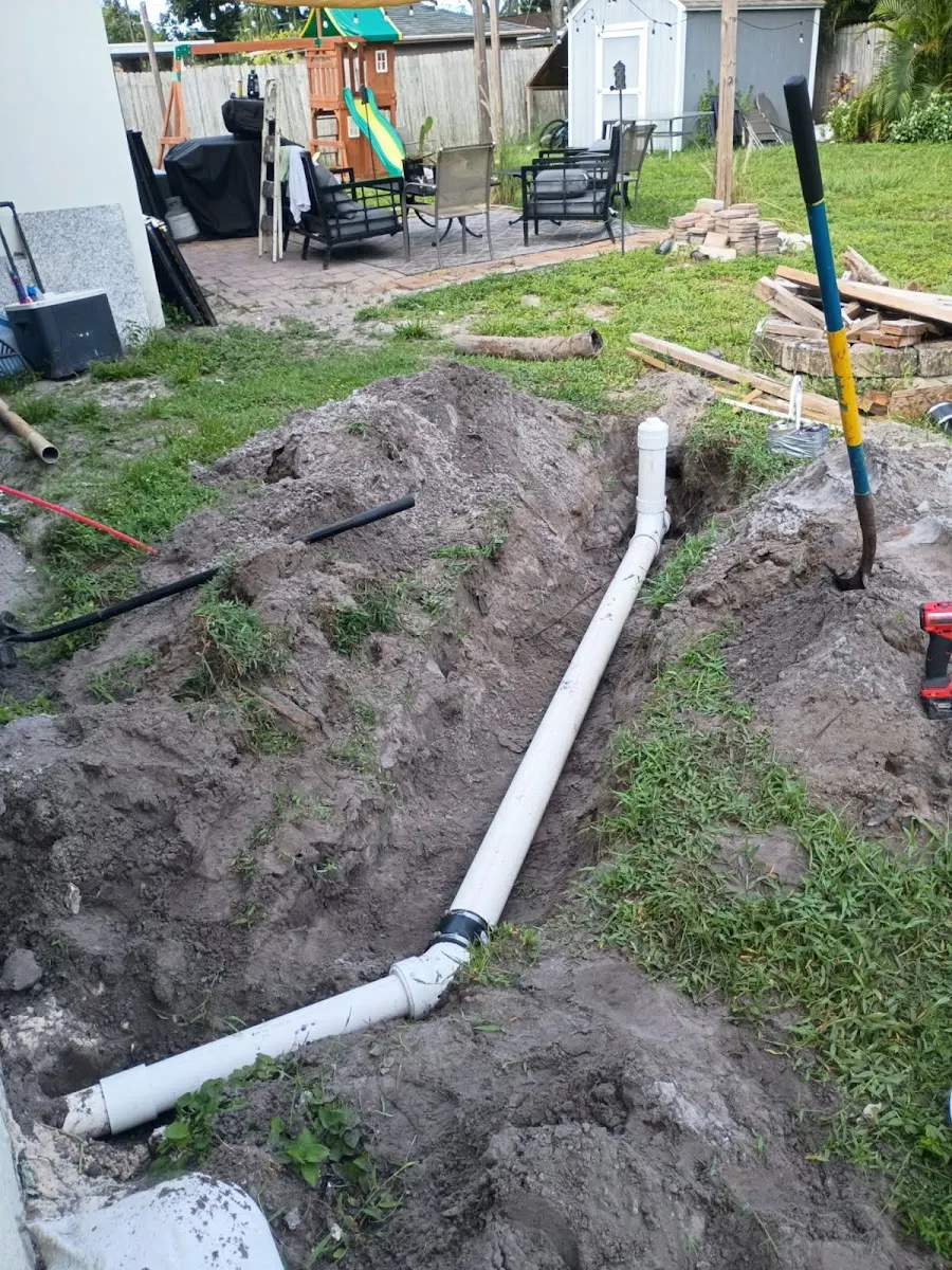 sewer line repair installation largo fl Underground residential sewer line repair and PVC pipe installation in an excavated trench in a backyard in Largo, FL.