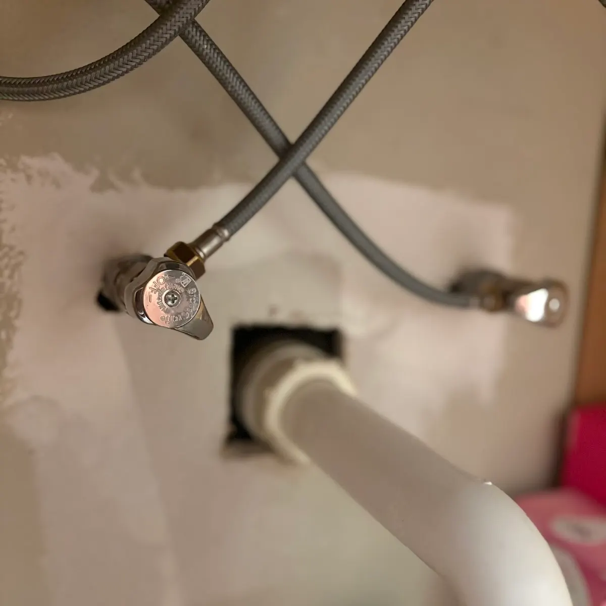Close-up View of New Under-Sink Plumbing Close-up view of new under-sink plumbing water shut-off valves and braided supply lines installed during a vanity repair in Largo, FL.