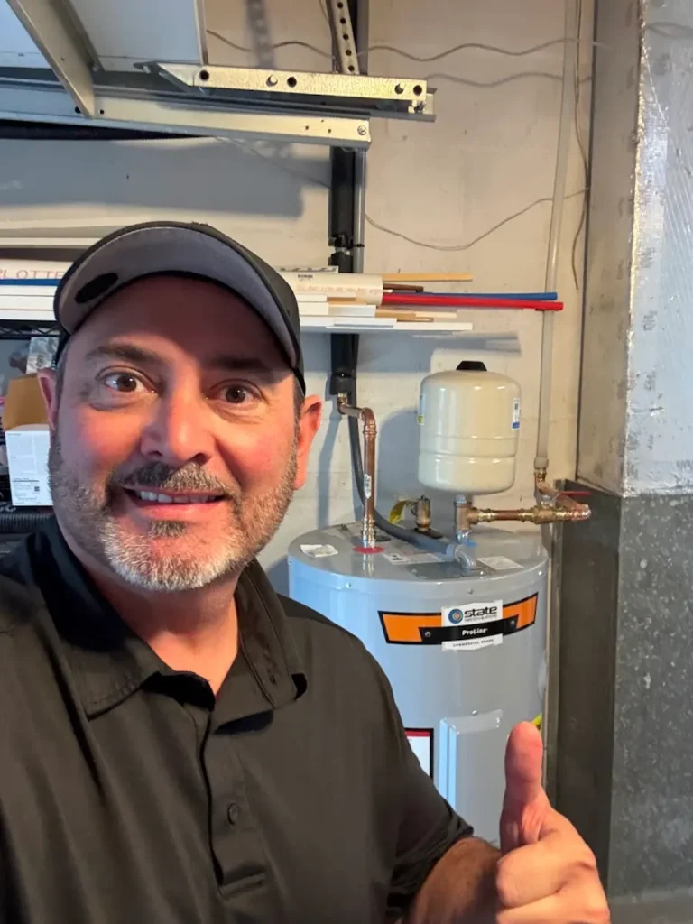 Shower valve toilet faucet install Largo Friendly local plumber giving a thumbs-up next to a newly installed State ProLine water heater with an expansion tank in a Largo, FL home.