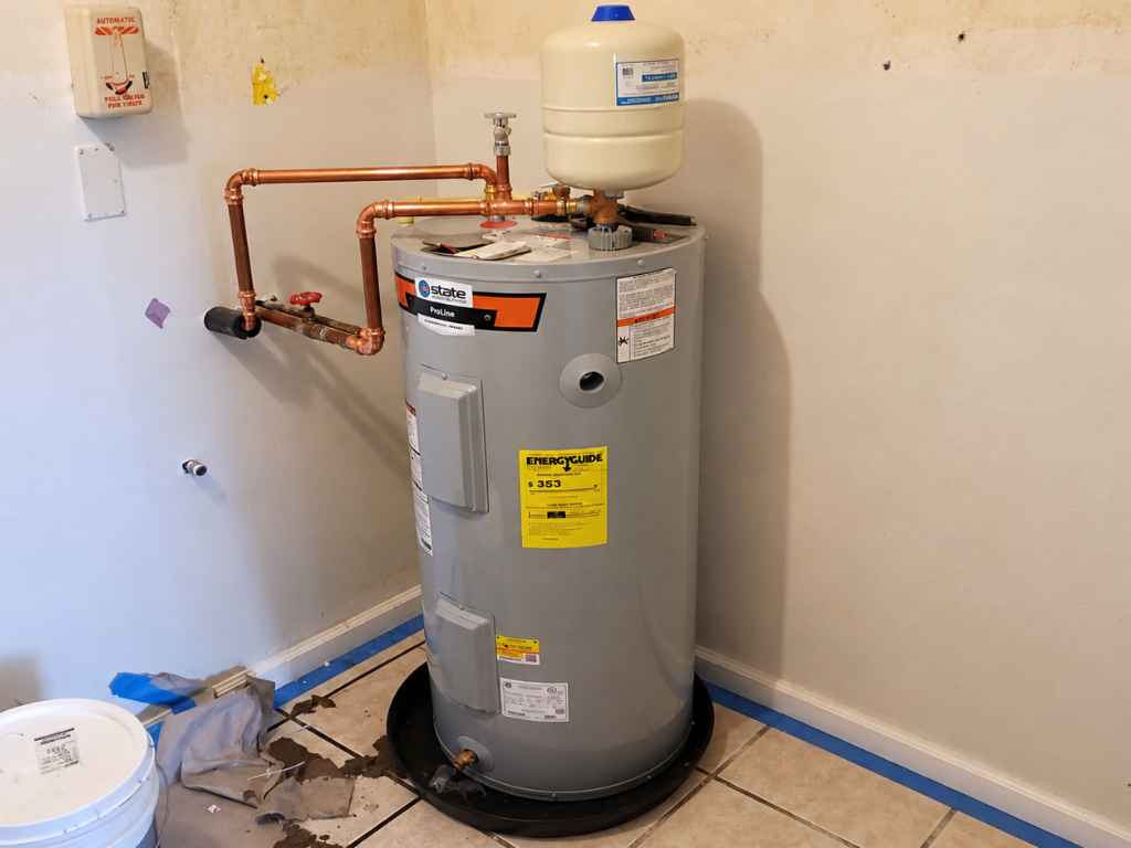 Water heater with expansion tank and copper piping, showing a relief valve connection.